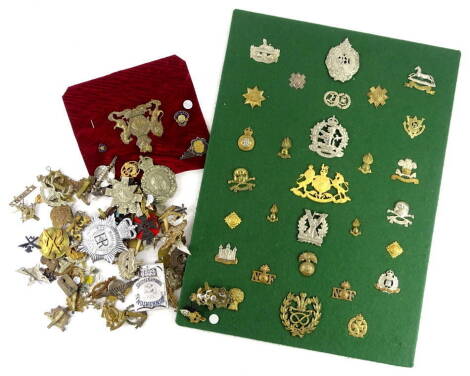 A collection of reproduction military cap and collar badges, including The Royal Suffolk's, The Gloucestershire Regiment, The Queens Own Hussars, The Fusiliers, The Third Dragoon Guards, in total approx 27 items.