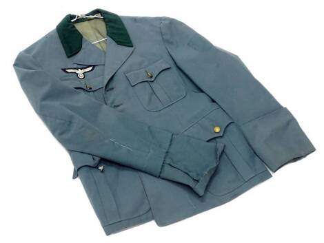 A German Third Reich style green jacket, applied with army pattern and National eagle badge, unmarked. (AF)