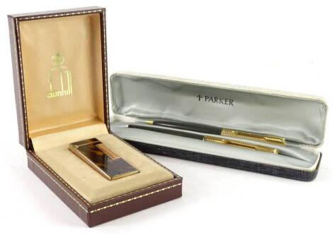 A Dunhill lighter, with simulated tortoise shell decoration, and a Parker pen set in original box. (2)