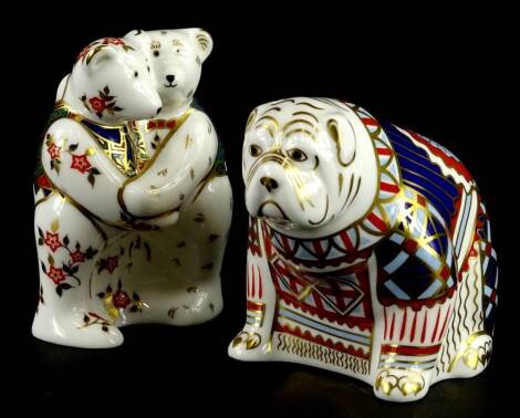 Two Royal Crown Derby porcelain paperweights, a bulldog signed to the underside by John Ablitt, printed mark in red and gold button, and a pair of embracing teddy bears, printed mark in red, no gold button.