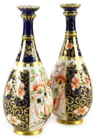 A pair of Royal Crown Derby bottle shaped vases, each decorated with Imari pattern, printed mark in red to underside, 18.5cm H.