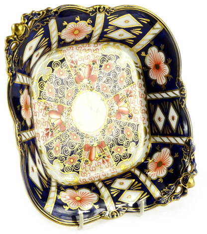 A Royal Crown Derby lozenge shaped two handled dish, decorated in the Imari pattern, with pierced handles and feet, printed mark in dark pink to underside, 26cm W.