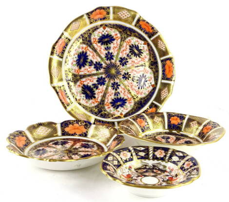 Four items of Royal Crown Derby porcelain, each decorated with the Imari pattern to include a plate with a shaped border, and three bowls, the largest 22cm dia.