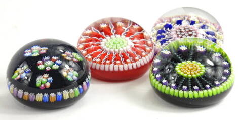 A collection of four glass millefiori paperweights, various designs, to include Perthshire, the largest 7cm dia.