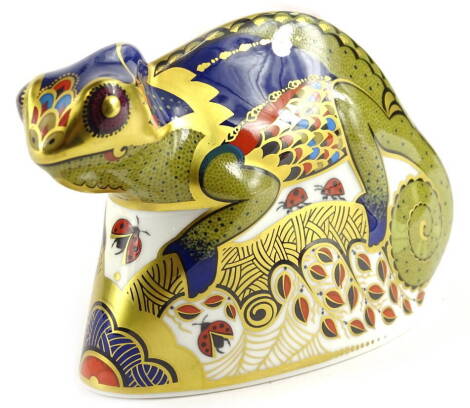 A Royal Crown Derby porcelain chameleon paperweight, decorated in Imari colours, printed mark in red to underside and silver coloured button, 14cm L.