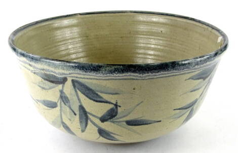 A Studio pottery bowl, decorated with leaves in deep blue, monogram to underside NCG; 36cm dia.