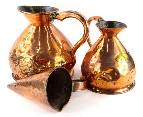 Two copper flagons, two gallons and a gallon, and a tapering vessel or jug. (3)