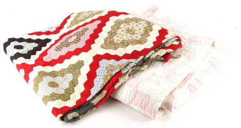 A patchwork quilt, decorated with various coloured fabrics, and another quilt. (2)