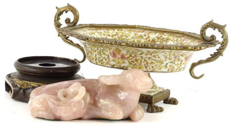 An oriental rose quartz carving of two buffalo, 20cm W, and an oriental and gilt metal stand.