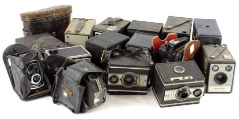 A collection of boxed cameras, and a pair of binoculars.