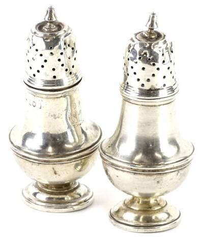 A pair of silver baluster shaped pepper pots, marks rubbed, 3oz.