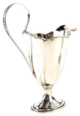 An Edward VII silver helmet shaped cream jug, the reeded handle decorated with acanthus, etc, Birmingham 1908, 3oz.