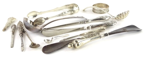 A collection of small silver, to include ladle, sifter spoon, sugar tongs, shoe horns, etc.