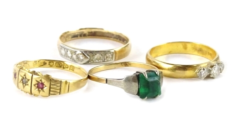 Four various rings, comprising a dress ring set with three CZ stones, gold coloured, but marked 900, a Victorian 18ct gold dress ring, set with garnet and diamond (AF), 2.3g all in, a 9ct gold and silver dress ring, set with green stone, 1.3g all in, and 