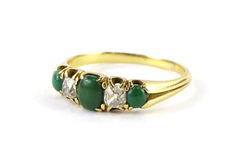 A jade and diamond dress ring, set with three jade stones, one central oval cut, and two round cut, with two old cut diamonds, each in claw setting, with two row splay design shoulders, yellow metal, unmarked, ring size O½, 2.8g all in.