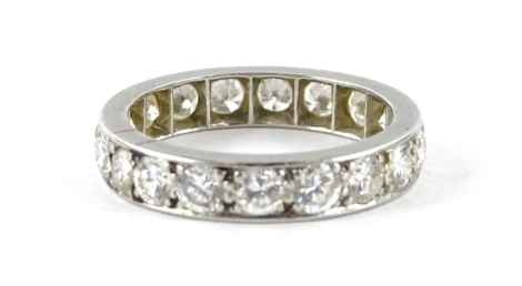 A diamond eternity ring, set with nineteen round brilliant cut diamonds, each in claw setting, approx 0.05cts each, total estimated carat weight 0.95cts, white metal setting, unmarked, ring size O½, 4.9g all in.