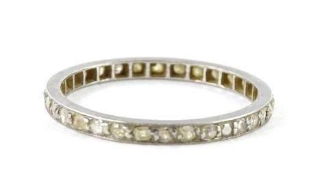 A thin diamond eternity ring, set with tiny old cut diamonds, in white metal setting, unmarked, ring size O, 1.8g all in.