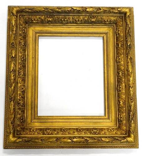 A late 19thC/ early 20thC decorated gilt picture frame, decorated with acanthus leaves, 70cm x 62cm.