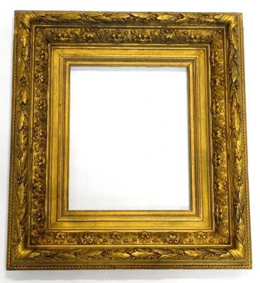 A late 19thC/ early 20thC decorated gilt picture frame, decorated with acanthus leaves, 70cm x 62cm.