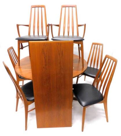 A retro style teak part dining room suite, comprising an extending dining table, with one loose leaf, and six chairs, each with a black leatherette padded seat, on turned legs. The upholstery in this lot does not comply with the 1988 (Fire & Fire Furnish