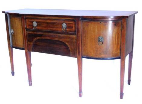 An Edwardian mahogany and satin wood cross banded sideboard, with two central drawers flanked by two bowed doors, each with gilt metal lion mask handles, on square tapering legs, 167cm wide.