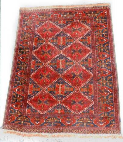 A Turkoman style rug, with a design of lozenges on a navy ground, one wide and two narrow borders, 137cm x 104cm.