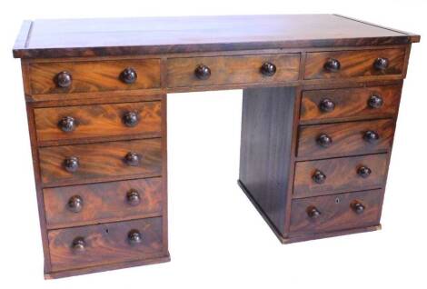 A 19thC mahogany dressing table, the rectangular top above an arrangement of eleven drawers, each with turned wood handles on shallow plinth, adapted, 129cm wide.