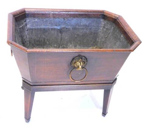 A 19thC mahogany cellarette, the rectangular top with canted corners enclosing a lead lined interior, the sides with four gilt metal lion mask handles, on square tapering legs, with castors, 69cm wide.