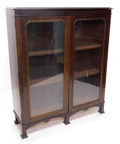 A Victorian mahogany bookcase, the top with a moulded cornice above two glazed doors, enclosing shelves on later square section feet, 114cm W.