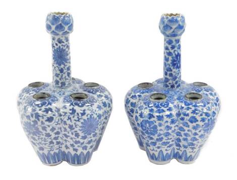 A near pair of Chinese Qing Dynasty blue and white tulip vases, of delft ware form long necked five section lobed form, decorated with flowers and scrolling leaves, 27cm H.