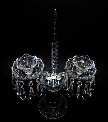 A Waterford crystal twin branch candelabrum, with a central faceted spike and faceted drops, raised on a baluster stem and conical foot, 49cm H.