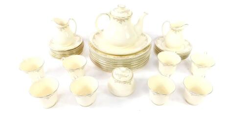 A Royal Doulton porcelain part dinner and tea service, decorated in the Giselle pattern, The Romance Collection, comprising twelve dinner plates, teapot, bread plate, pair of cream jugs, sucrier, eight cups, seven saucers and eight tea plates.