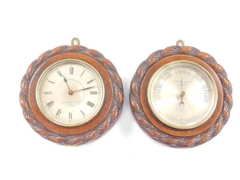 A French early 20thC oak cased wall clock and matching barometer, by Salom & Co Paris, silvered dials, the case with rope twist carving, with key, 14.5cm D. (2).