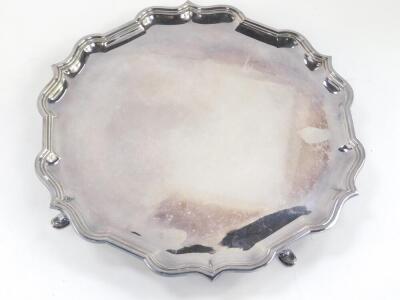 A silver piecrust salver, raised on four hoof feet, Sheffield 1971, 27.15oz, 31cm Dia. - 2