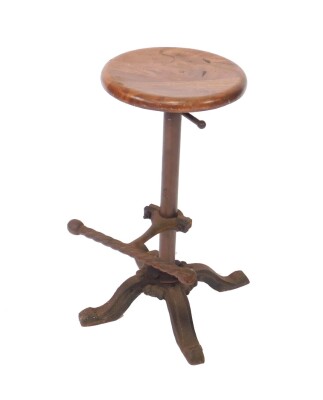 A Victorian cast iron machinist's stool, with an adjustable circular wooden seat, adjustable foot rest, raised on a cast iron base, with four cabriole legs, 90.5cm at full height, 62.5cm H at lowest height.