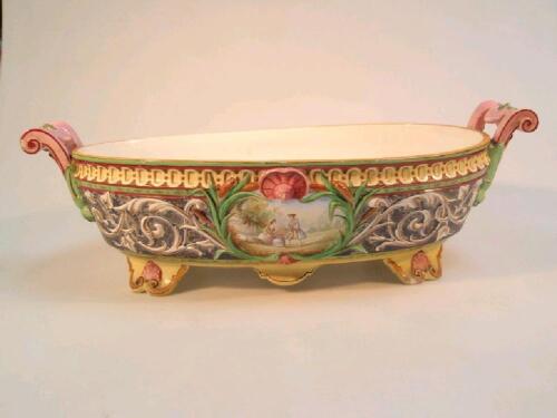 A continental Majolica jardiniere of boat shaped with two scroll handles