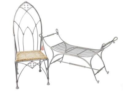 A wrought iron Roman style window seat, of curved form with scrolling arms, 124cm W, together with a wrought iron Gothic throne chair, with a cane seat, raised on double column legs, 125cm H. (2)