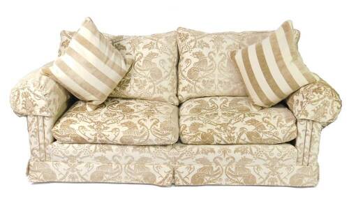 A Duresta two seater sofa, upholstered in fawn Gothic vine and lion fabric, together with two striped cushions, 226cm L.