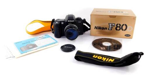 A Nikon F80D 35mm camera, with a Nikkor 28mm 1:3.5 lens No 2126843, boxed.