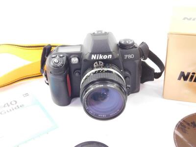 A Nikon F80D 35mm camera, with a Nikkor 28mm 1:3.5 lens No 2126843, boxed. - 2