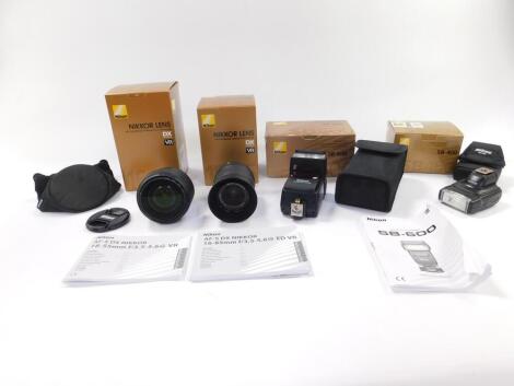 A Nikon DX digital Nikkor lens, AF-S DX-18-55mm F/3.5-5.6G BR, another lens 16-85mm F/3.5-5.6G ED BR, and SB-400 speed light and a SB-600 speed light, all boxed. (4)