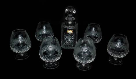 A set of six heavy cut glass brandy balloons, engraved with vines, together with a similar cut glass decanter and stopper (7).