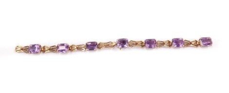 A 9ct gold and amethyst bracelet, set with seven emerald cut amethysts, on a snap clasp, 14.9g all in.