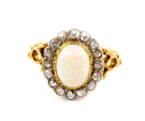 An opal and diamond ring, set in yellow metal, the cabachon opal set in a surround of sixteen old cut diamonds, approx 2/3cts, size S, 4.5g all in.
