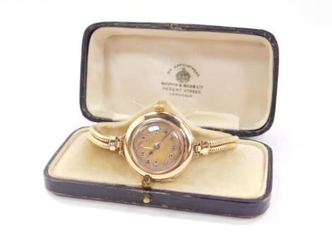 A Rolex early 20thC lady's 9ct gold cased wristwatch, circular dial, with Arabic numerals picked out in silver metal, 15 jewel movement, circular case with hinged back, on a plated two strand bracelet, Birmingham 1916, 26.1g all in.