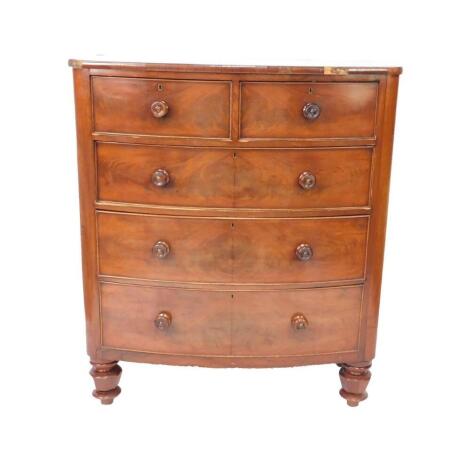 A Victorian mahogany bow front chest of drawers, with two short over three long graduated drawers, raised on turned feet, 133cm H, 115cm W, 57cm D.