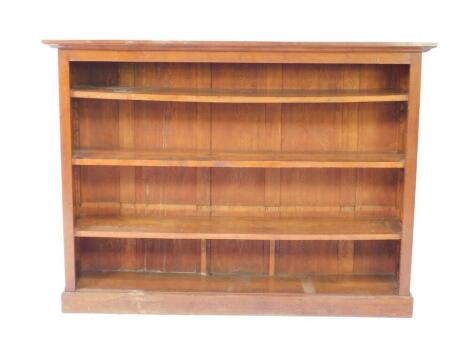 An oak open bookcase, the outswept pediment over three shelves, raised on a plinth base, 122cm H, 163cm W, 31cm D.