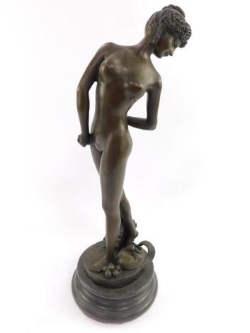 A bronze figure modelled as a classical naked lady, raised on a base with masks and balls, signed J Get. on a marble socle, 46cm H.