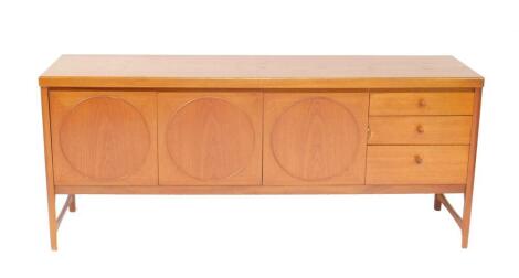 A Nathan teak sideboard, with three doors flanked to the right by three graduated drawers, raised on tapering square legs, united by stretchers, 182.5cm W, 45cm D, 78cm H.