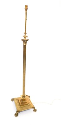 A brass Corinthian column standard lamp, raised on a stepped square base and paw and pad feet, 148cm H.